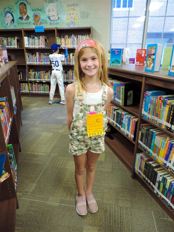 student smiling in library